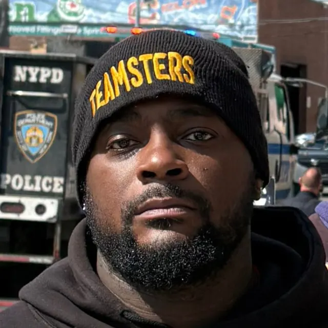 Darryl Beaton in a Teamsters beanie and a Local 804 hoodie, on a New York street.